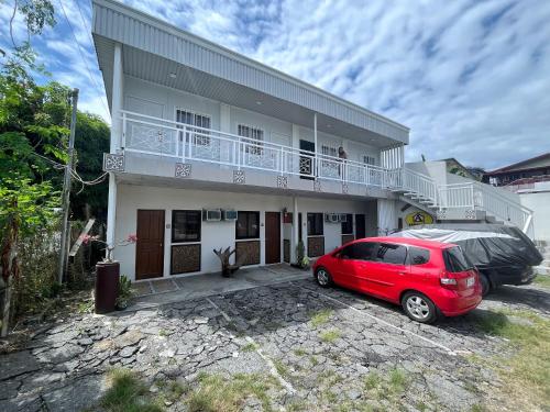 a red car parked in front of a house at A Residences in San Fernando