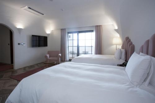 Ein Bett oder Betten in einem Zimmer der Unterkunft Ecoland Hotel