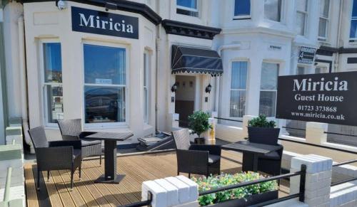 a rendering of a cafe with tables and chairs at Miricia Guest House in Scarborough