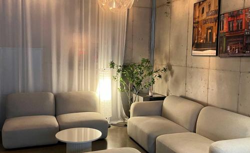 テグにあるHotel Crape Daegu Seongseoのソファとテーブルのあるリビングルーム