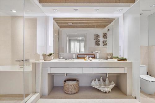 a bathroom with a sink and a mirror at Ultra Luxe Direct Ocean Penthouse at 1 Hotel in Miami Beach
