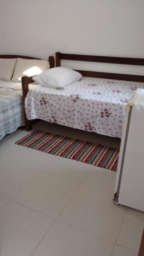 two beds sitting next to each other in a room at Hospedagem, Pouso Famíliar Paraty in Paraty