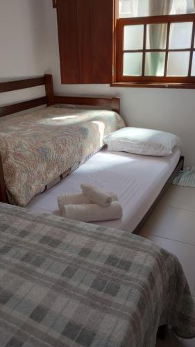 two beds sitting next to each other in a room at Hospedagem, Pouso Famíliar Paraty in Paraty