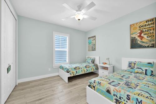 a bedroom with two beds and a ceiling fan at Relax at Home in Jax in Jacksonville Beach