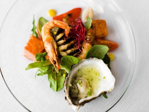 a plate of food with seafood and vegetables on it at Hotel Constancja in Częstochowa