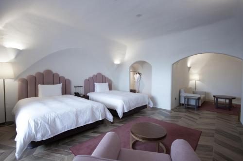 Ein Bett oder Betten in einem Zimmer der Unterkunft Ecoland Hotel