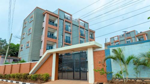 an apartment building with a garage in front of it at Serene Homes 03 in Kampala