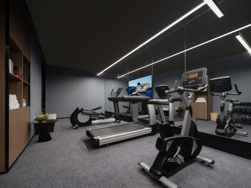 a gym with treadmills and exercise bikes in a room at Atour Hotel Xi'an South Yanta Road Jinhui Plaza in Xi'an