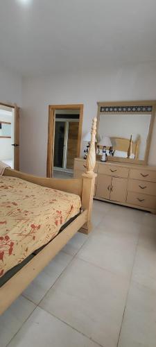 a bedroom with a bed and a large mirror at Vista al mar live in La Puntica de Juan Dolio