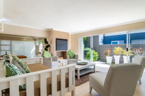 a living room with a couch and a table at Gem with indoor jacuzzi in Cape Town
