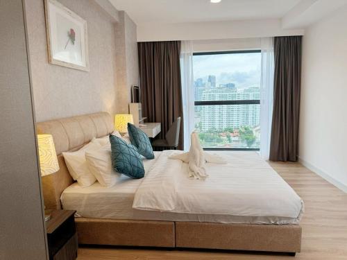 a bedroom with a large bed with a large window at The Atrium at Jalan Ampang by OKBnB - Luxury 3 Bedroom Family Suite with Balcony, 3 mins to KLCC in Kuala Lumpur