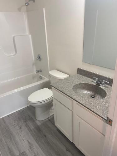 a white bathroom with a toilet and a sink at Warmth Private Room in Stillwater Lake Estates