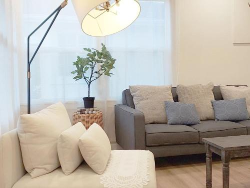 a living room with a couch and a table at Centrally Located Charming LA Home with Food Scenes in Monterey Park