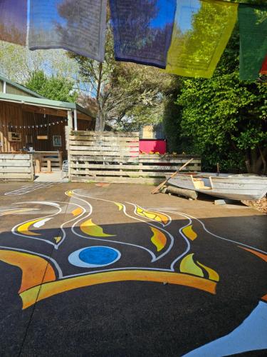 a painting on the ground in a parking lot at Forest Waters Raspberry Dream Cabin in Haruru