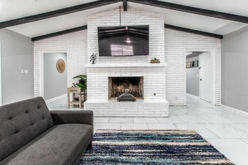 a living room with a couch and a fireplace at Contemporary Coastal Oasis Awaits in Corpus Christi