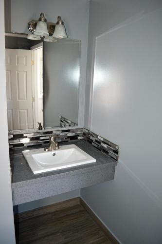 a bathroom with a sink and a mirror at Rex Motel in Ventura