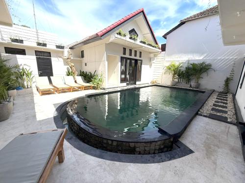 a swimming pool in the backyard of a house at Villa KAS Legian Seminyak - 6 Bedroom Villa in Seminyak