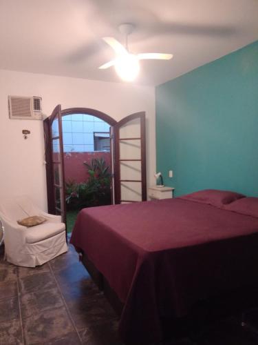 a bedroom with a bed and a ladder in it at Casa Praia Jardim Acapulco in Guarujá