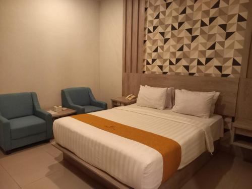 Ένα ή περισσότερα κρεβάτια σε δωμάτιο στο Urbanview Hotel Dedy Jaya Brebes