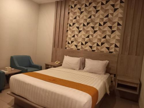 Ένα ή περισσότερα κρεβάτια σε δωμάτιο στο Urbanview Hotel Dedy Jaya Brebes