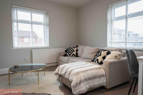 a living room with a couch and a table at Apartment near Blackpool Central & Pleasure Beach in Blackpool