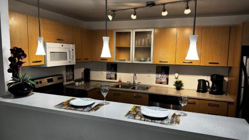 a kitchen with wooden cabinets and a white counter top at Ocean Reserve Miami Luxury Rentals in Sunny Isles Beach