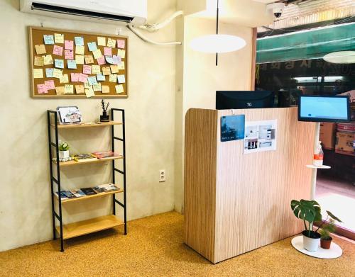 ソウルにあるSSH LK Hostelの木製の仕切りと棚が備わるお部屋
