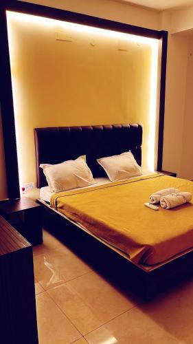 a bedroom with a large bed with a large window at Jerry's Chateau in Puducherry