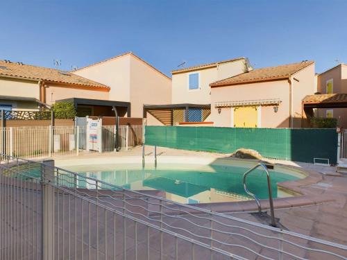 une piscine devant une maison dans l'établissement Appartement 2 Pièces RDC avec Terrasse et Parking dans Résidence Sécurisée avec Piscine - FR-1-326-846, à Marseillan