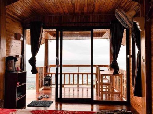 a room with a balcony with a view of the ocean at วิมานหมอก ภูทับเบิก in Ban Maeo Thap Boek