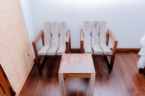 two wooden chairs sitting in a room at Hilltop villas in Mirissa