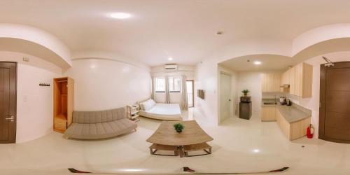 a living room with a couch and a table at Urban Nest with a View in Iloilo City