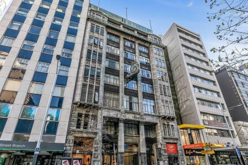a tall building with a clock on the front of it at Historic Modern Luxury 1-Bedroom on Queen Street in Auckland