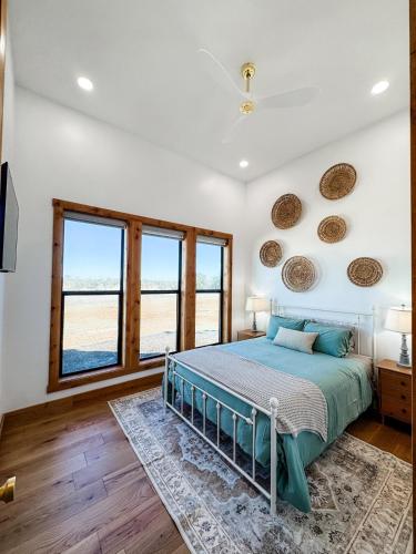 a bedroom with a bed and a large window at Sunday House at The Sanctuary in Fredericksburg