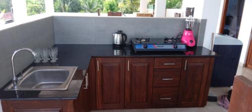 a kitchen with a sink and a counter top at Ruvini Villa in Hikkaduwa
