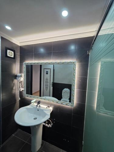 a bathroom with a sink and a mirror at Apparte Tétouan Climatisé 2 Chambre et Securisé in Tetouan