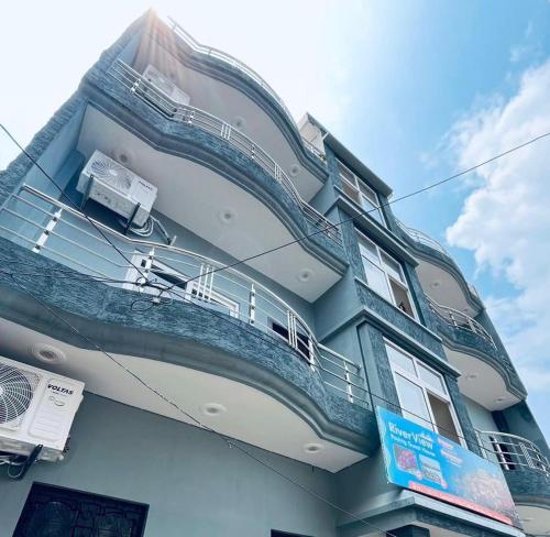 a blue building with a balcony on the side of it at River view paying guest house in Varanasi
