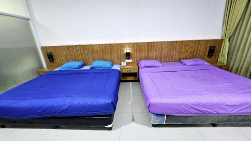Katil atau katil-katil dalam bilik di New Tiga Intan Hotel