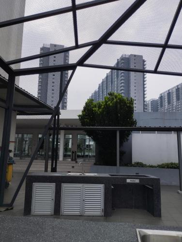 a view of a building with tall buildings in the background at The Luxe Lodge in Southville City in Bangi