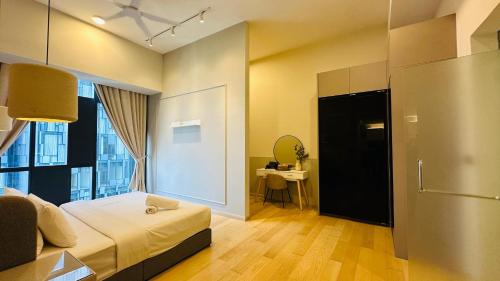 a bedroom with a bed and a room with a table at Star Residence Suite KLCC in Kuala Lumpur