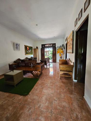 a living room with a couch and a table at Nirun Garden Villa - Balinese Traditional House in North Bali in Ambengan