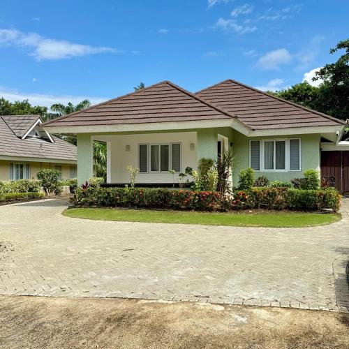 a house with a driveway in front of it at Jamnick Vacation Rentals - Fern Court, Richmond Estate, St Ann, Jamaica in Ocho Rios