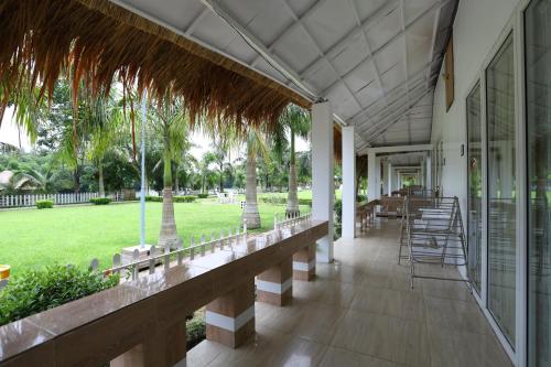 a porch of a resort with chairs and tables at Rangauti Resort in Binesri