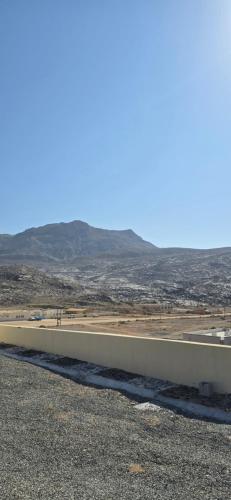a long white wall on the side of a road at Sunset view hill jabal shams in Misfāh
