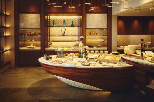 a large room with a wooden boat in it at ANA InterContinental Manza Beach Resort by IHG in Onna