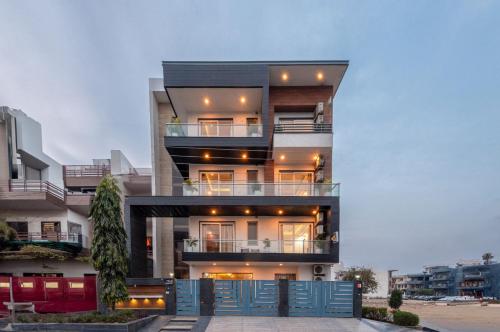 a tall building with blue doors in front of it at Hotel Florence near Artemis Hospital in Gurgaon