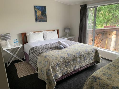 a bedroom with two beds and a window at Private Rooms with Shared Bathroom in Lake Tekapo