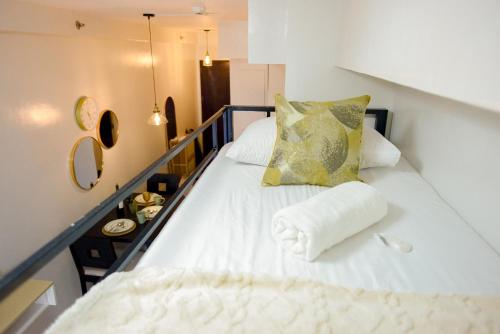 a large white bed in a small room at Cozy Davao Studio with Queen and Bunk Bed Near Abreeza Mall in Davao City