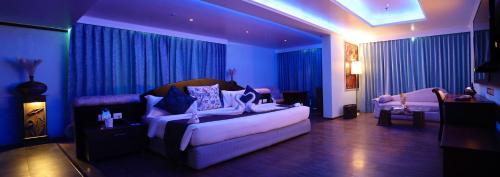 a living room with a white couch in a room at The Quilon Beach Hotel and Convention Center in Kollam