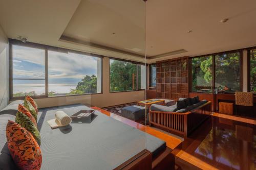 a living room with a view of the ocean at Sankara Hotel & Spa Yakushima in Yakushima